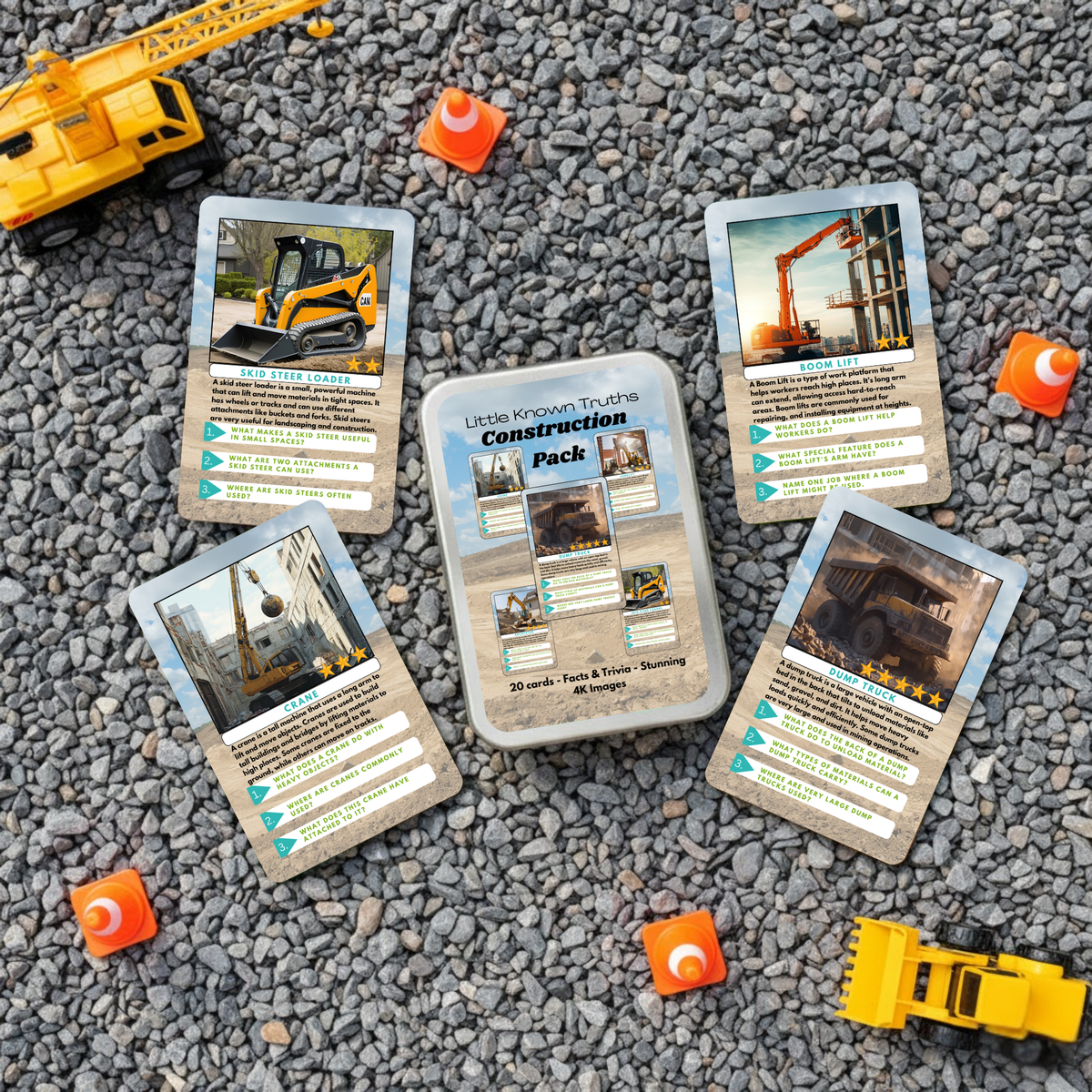 Construction-themed learning trading cards on a gravel surface with toy construction vehicles.